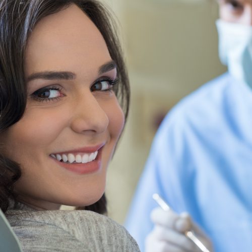 Smiling woman at dentist Smiling young woman receiving dental checkup